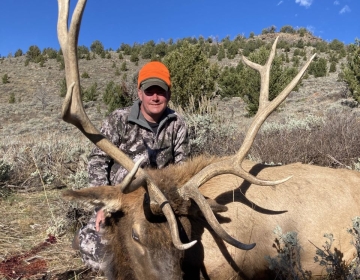 An SNS client posing after the hunt with his 6x6 bull elk